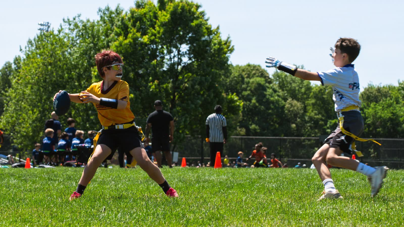 A quarterback in a Commanders jersey sets to throw as a rusher closes in