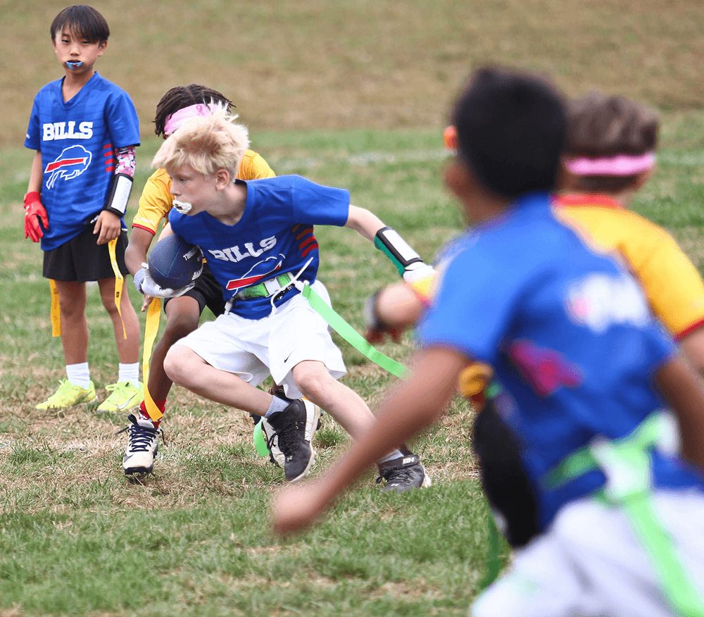Flag football players race toward the ball during a game