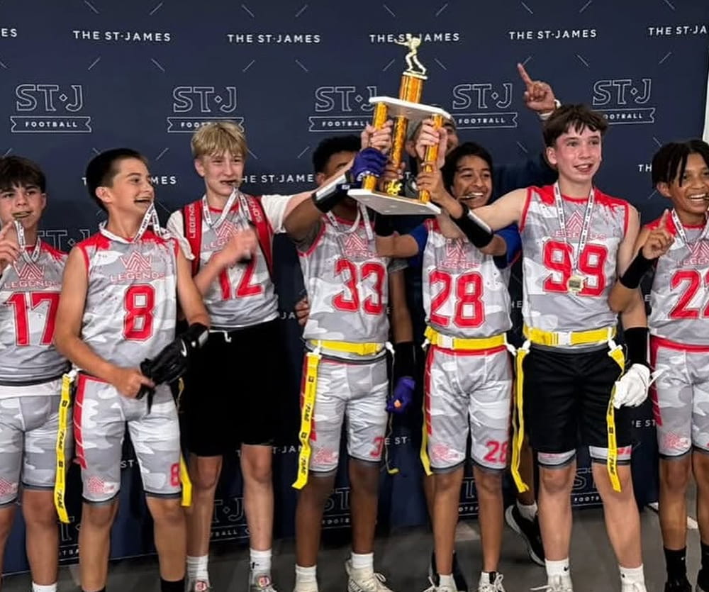 Aim High Legends players celebrate with a tournament trophy