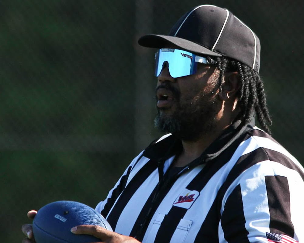 An Aim High referee holds the game ball